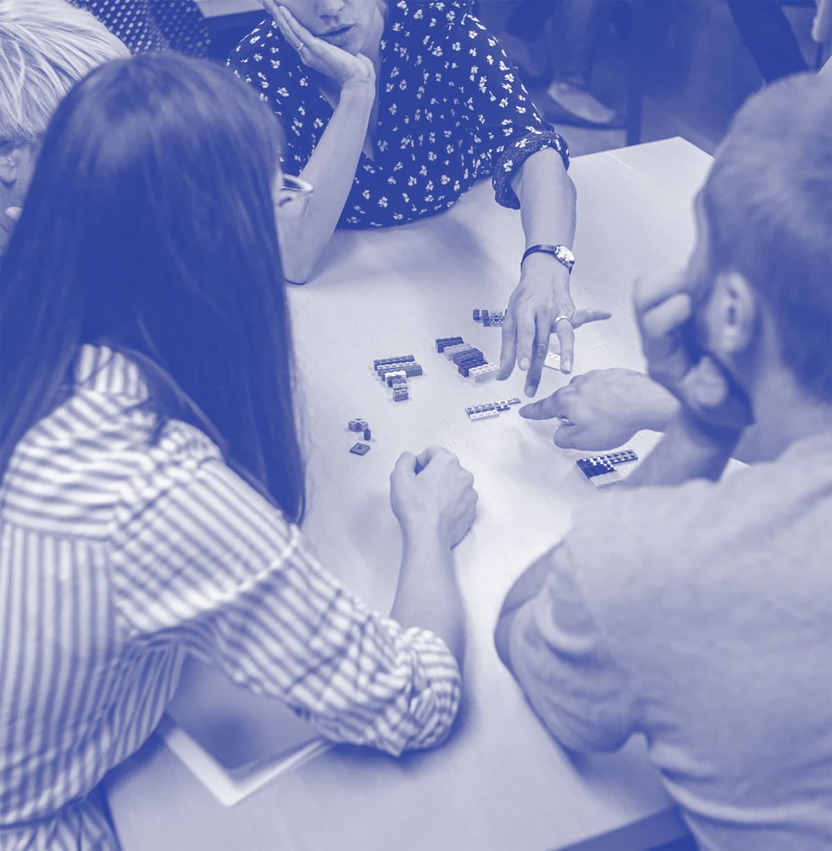 People participating in a workshop using lego pieces